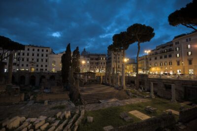 The Roman ruins of the Largo Argentina in Rome, after dark with a dramatic sky